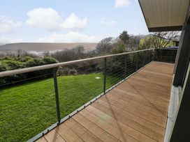 A deck with railing and a view of grass and landscape at Green Shutters in Freshwater East near Lamphey