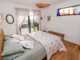 A bedroom with a bed and decorative bottles at Green Shutters Freshwater East near Lamphey