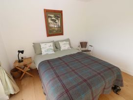 A bedroom with a bed and artwork at Green Shutters Freshwater East near Lamphey