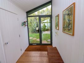 A hallway with a bench and glass door at Green Shutters Freshwater East near Lamphey