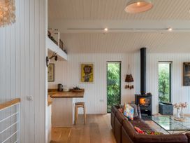 A living room with a coffee table and windows at Green Shutters in Freshwater East near Lamphey