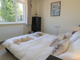A bedroom with a bed and dresser at Bayview Cottage Southbourne