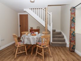 A dining area with a table and chairs at Aunty Junes Cottage Okehampton
