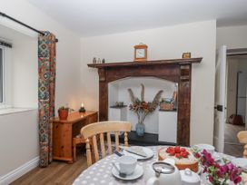 A dining room with a table and cake at Aunty Junes Cottage in Okehampton