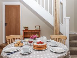 A dining room with a table set for tea at Aunty Junes Cottage in Okehampton