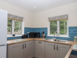 A kitchen with a sink, microwave, and toaster at Aunty Junes Cottage Okehampton