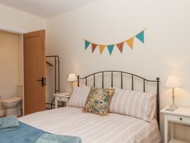 A bedroom with a bed and bedside table at Aunty Junes Cottage Okehampton