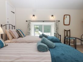 A bedroom with two beds and a window at Aunty Junes Cottage Okehampton