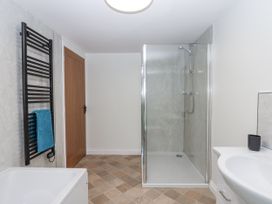 A bathroom with a shower and a bath tub at Aunty Junes Cottage in Okehampton