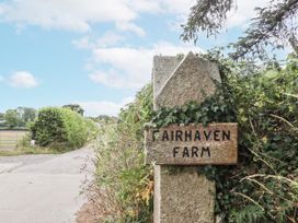 A sign for Fairhaven Farm by the side of a road in Okehampton