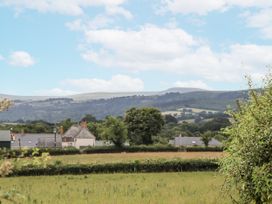 A view of houses and fields with hills in the background at Aunty Junes Cottage Okehampton