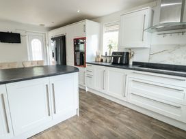 A kitchen with cabinets and appliances at 9 Beckett Close Colwyn Bay
