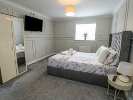 A bedroom with a bed and TV at 9 Beckett Close in Colwyn Bay