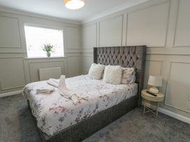 A bedroom with a bed and bedside table at 9 Beckett Close in Colwyn Bay