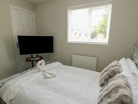 A bedroom with a bed and television at 9 Beckett Close Colwyn Bay