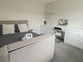 A bedroom with a bed and dresser at 9 Beckett Close Colwyn Bay