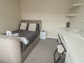 A bedroom with a bed and a desk at 9 Beckett Close Colwyn Bay