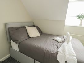 A bedroom with a bed and towels arranged at 9 Beckett Close Colwyn Bay