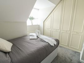 A bedroom with a bed and wardrobe at 9 Beckett Close in Colwyn Bay
