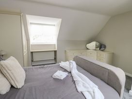 A bedroom with a bed and dresser at 9 Beckett Close in Colwyn Bay