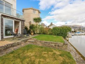 An outdoor area with seating chairs and a view of the marina at Oakley View Apartment in Porthmadog