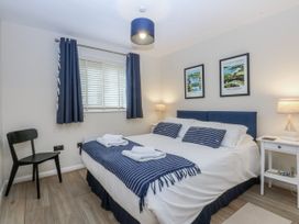 A bedroom with a bed and bedside table at Oakley View Apartment in Porthmadog