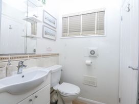 A bathroom featuring a sink and toilet at Oakley View Apartment in Porthmadog