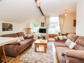 A living room with sofas and a coffee table at 2 Bakers Yard
