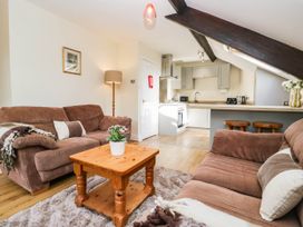 A living room with sofas and a coffee table at 2 Bakers Yard