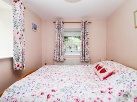 A bedroom with a bed and window at 2 Bakers Yard