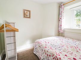 A bedroom with a bed and wardrobe at 2 Bakers Yard