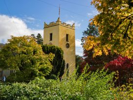 A tower with a clock and trees at 2 Bakers Yard