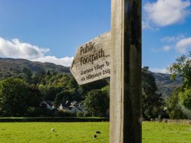 A signpost indicating public footpath near fields at 2 Bakers Yard 