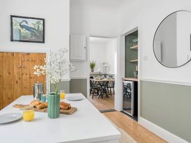 A dining room with a table set for breakfast at Palm House in Newquay
