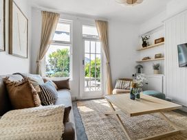 A living room with a sofa and table at Palm House in Newquay
