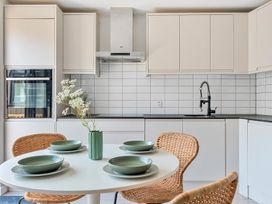 A kitchen with a round table and chairs at Palm House in Newquay