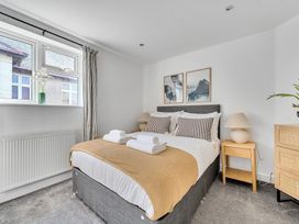 A bedroom with a bed and bedside table at Palm House in Newquay