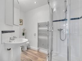 A bathroom with a sink, toilet, and shower at Palm House in Newquay