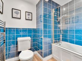 A bathroom with a bathtub and shower at Palm House in Newquay