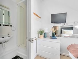 A bathroom with a shower and sink at Palm House in Newquay