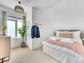 A bedroom with a bed and plant at Palm House in Newquay