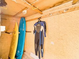 A storage area with surfboards and wetsuits at Palm House in Newquay