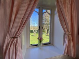 A window with tulips in a vase at Cefn Campstone Llanvihangel Crucorney near Abergavenny