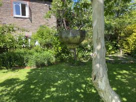 A garden with a tree and decorated bowl at Cefn Campstone Llanvihangel Crucorney near Abergavenny