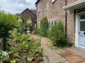 A garden with flowers and gravel pathway at Cefn Campstone Llanvihangel Crucorney near Abergavenny