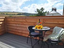 An outdoor terrace with a table and chairs at The Halt in Maiden Newton