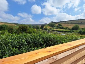 A landscape view with greenery and hills at The Halt in Maiden Newton
