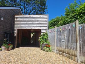 An outdoor area with gravel and a wooden building at The Halt in Maiden Newton