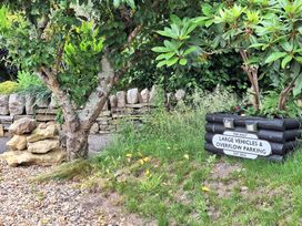An outdoor area with a parking sign and trees at The Halt in Maiden Newton