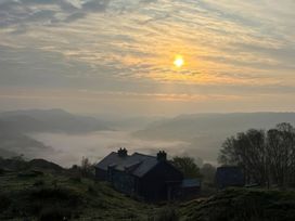 A scenic view of houses and hills during sunrise at Ty Llugwy in Capel Curig near Betws-Y-Coed